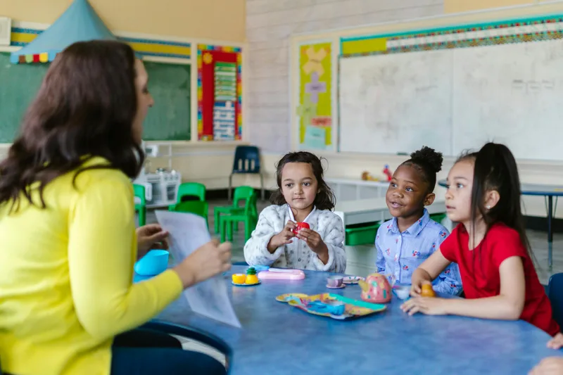 Educator guiding young students in a hands-on session